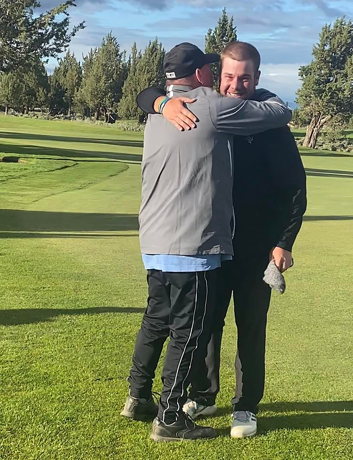 Marty Marquez / Courtesy Photo.Chehalis' Brady Calkins, right, gets a hug from his dad, Kelly, after finishing first at a U.S. Open qualifier last Monday in Bend, Oregon.